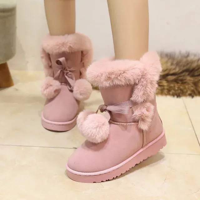 Elegant winter boots with pompom embellishment